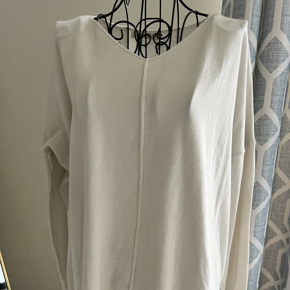 Cream colored v neck sweater with seam detailing